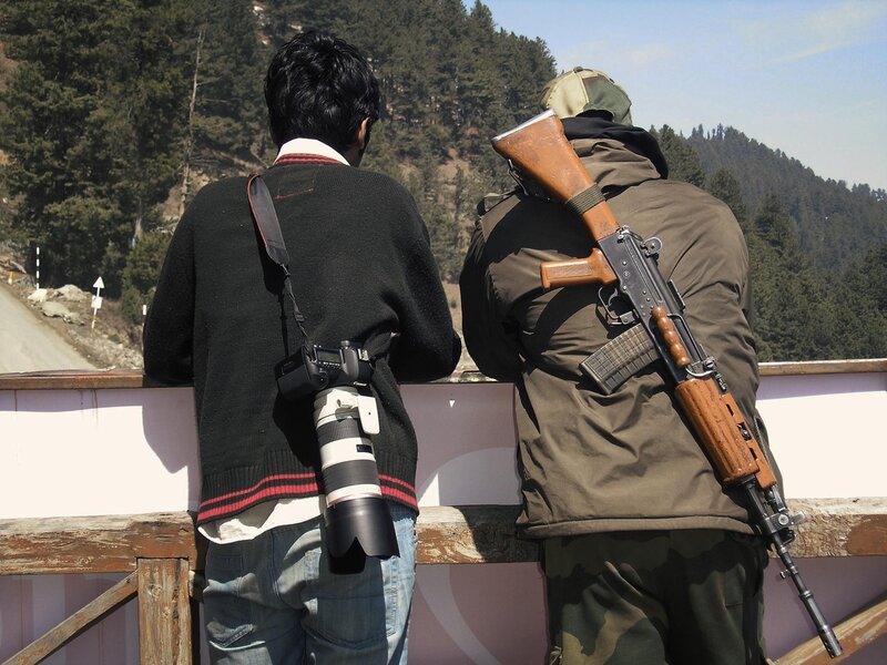 Tourist with photographer and soldier