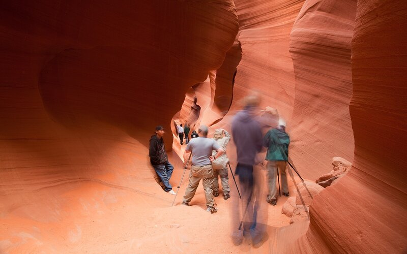Tourists in a red sandstone canyon