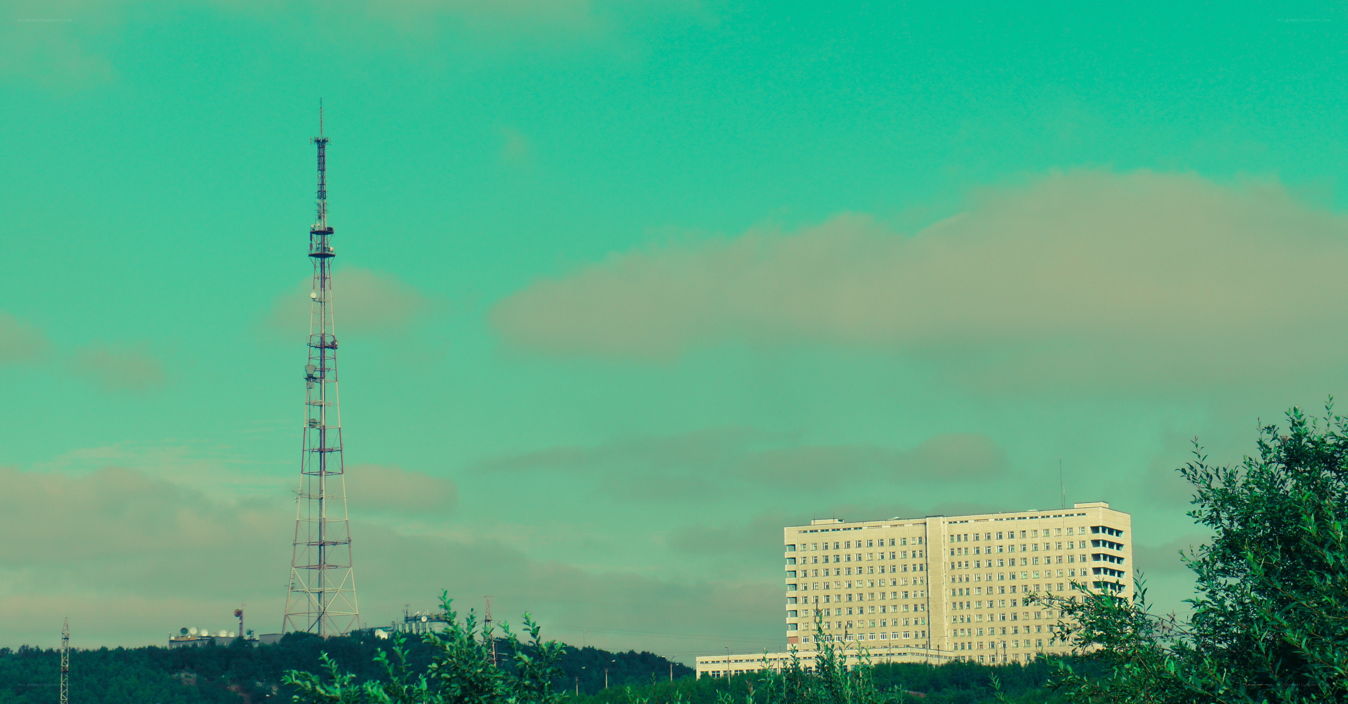 tower and building under cloudy sky