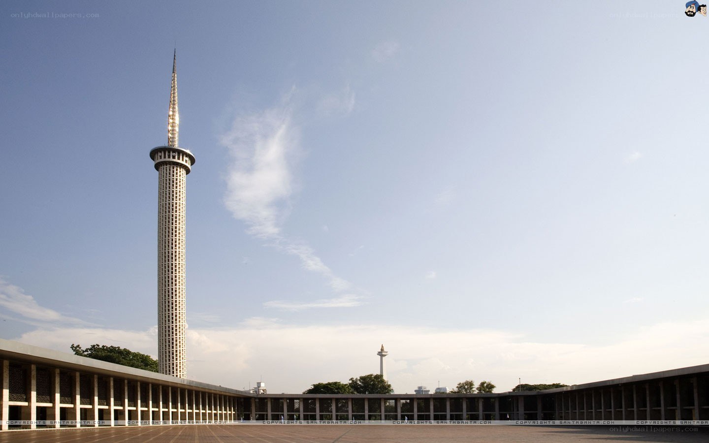 Towering minaret against blue sky