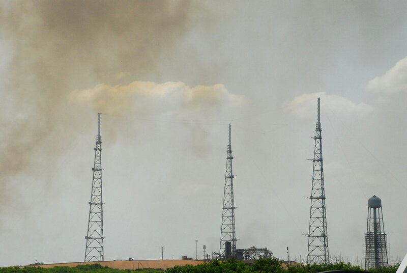 towers with smoke in the sky