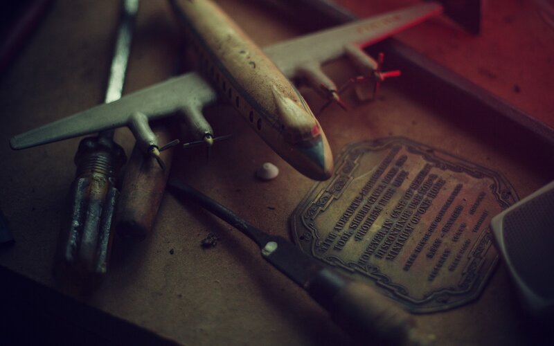 Toy Airplane on Workbench — Brown