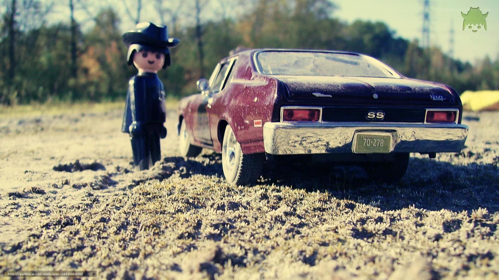 Toy car and figure in field