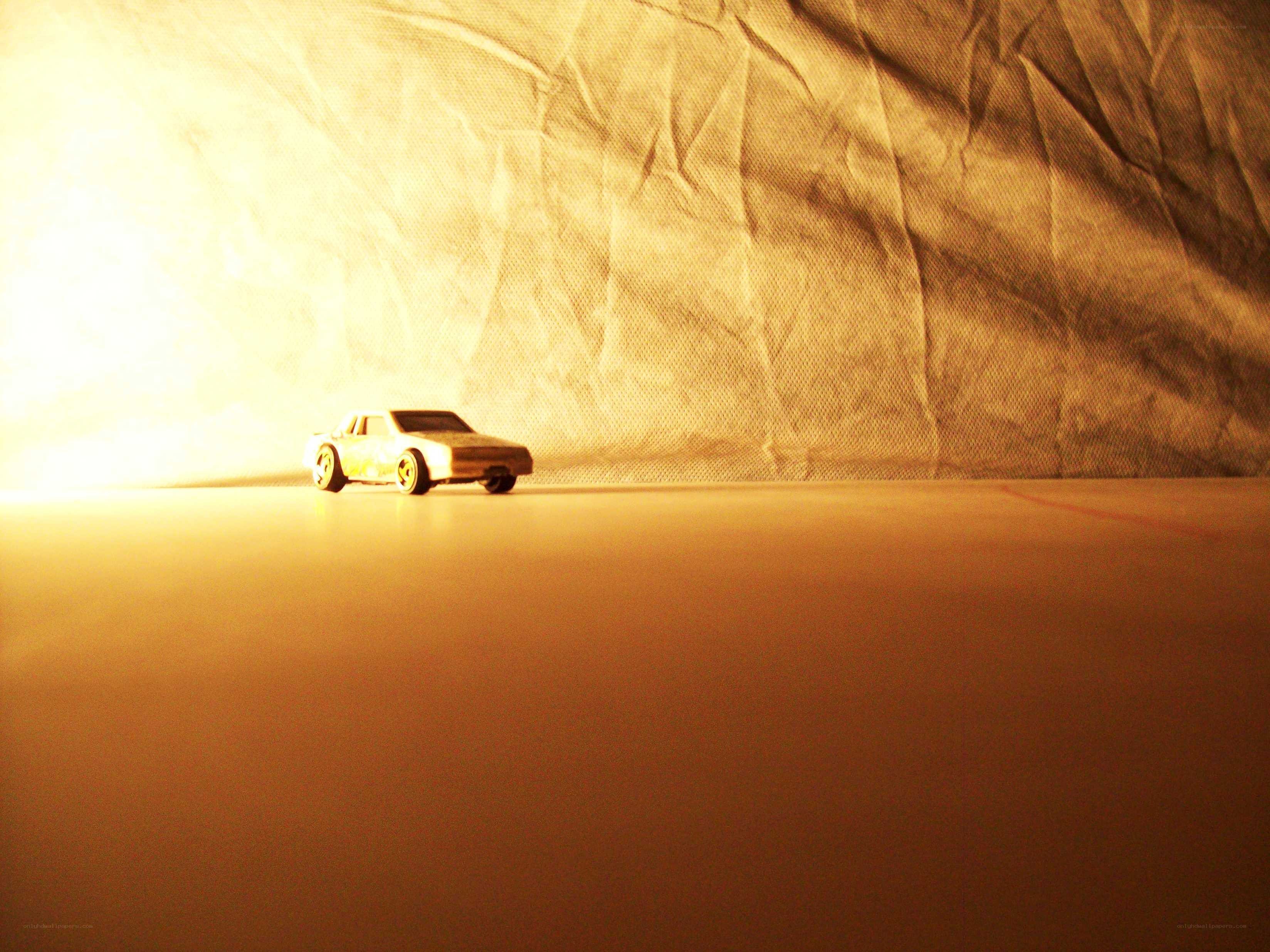 Toy car on a warm-lit surface