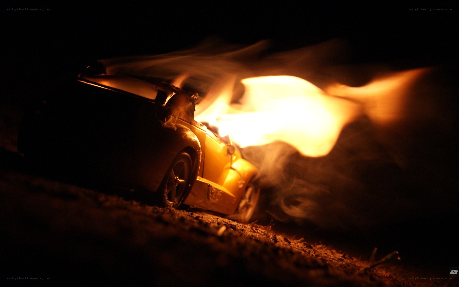 Toy car on fire at night