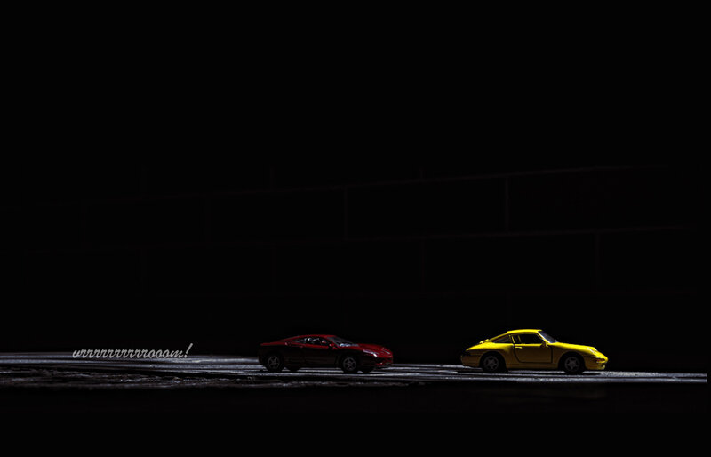 Toy cars on a dark road