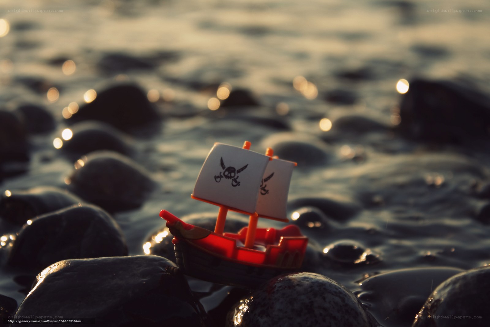 Toy pirate ship on rocks