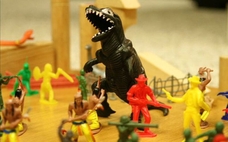 Toy soldiers and dinosaur battle