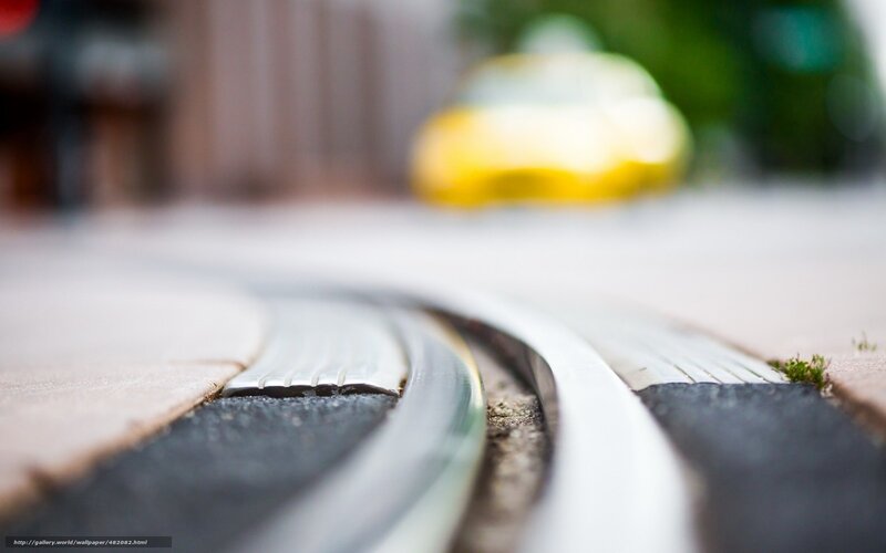 Toy train tracks on pavement
