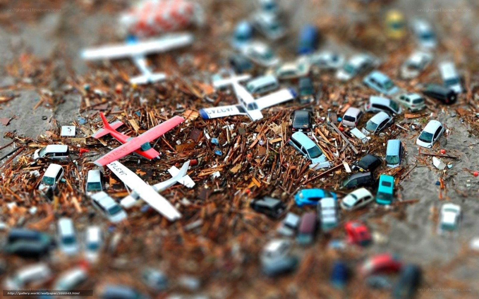 Toy vehicles in debris