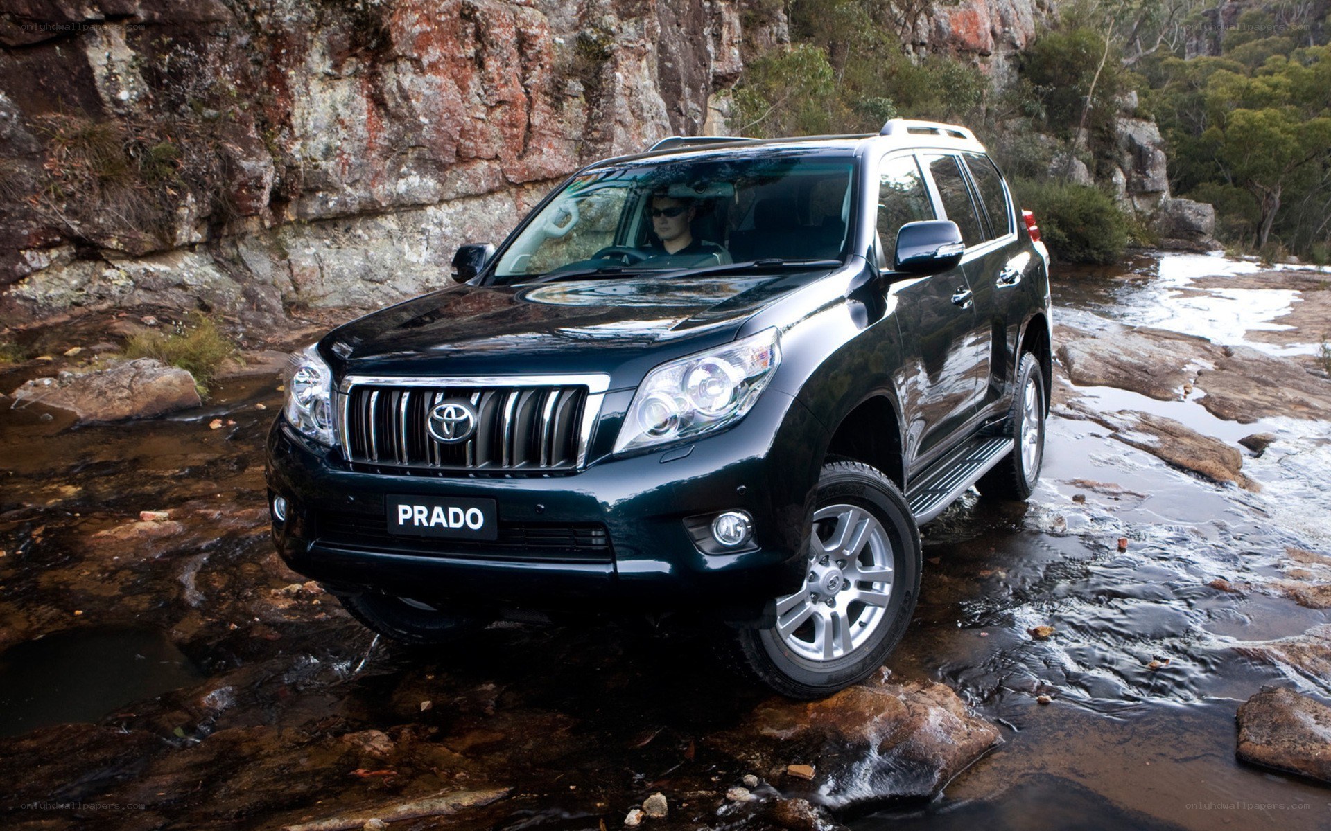 Toyota Prado in a stream