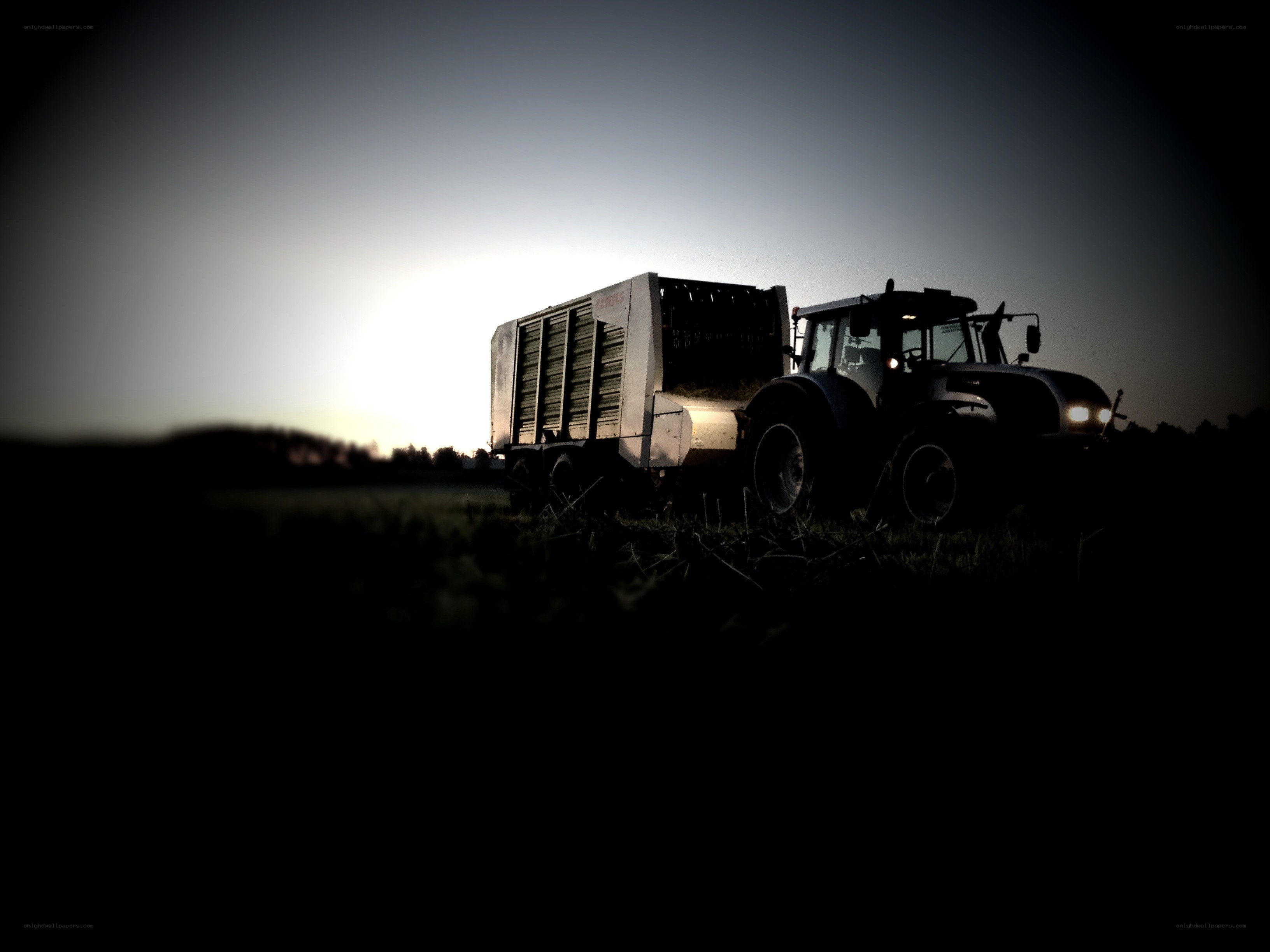 Tractor at dusk in a field