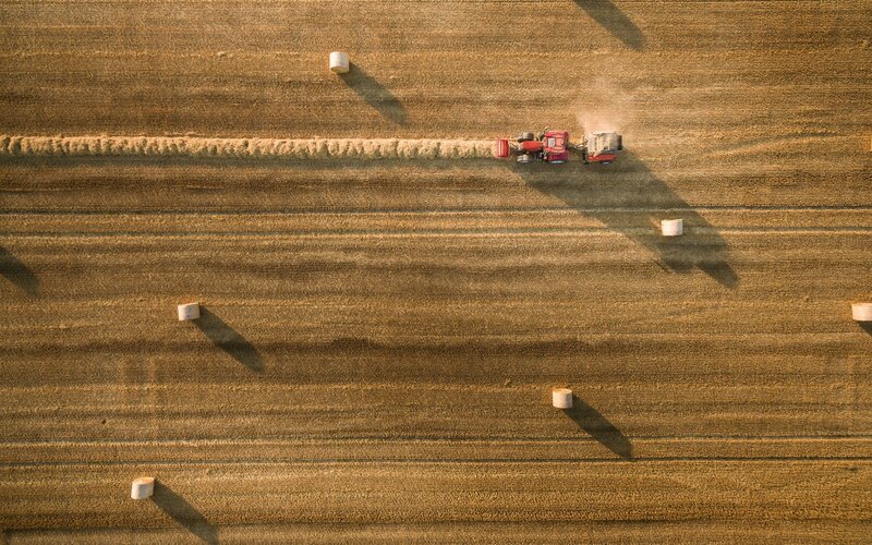 Tractor Baling Hay — Brown