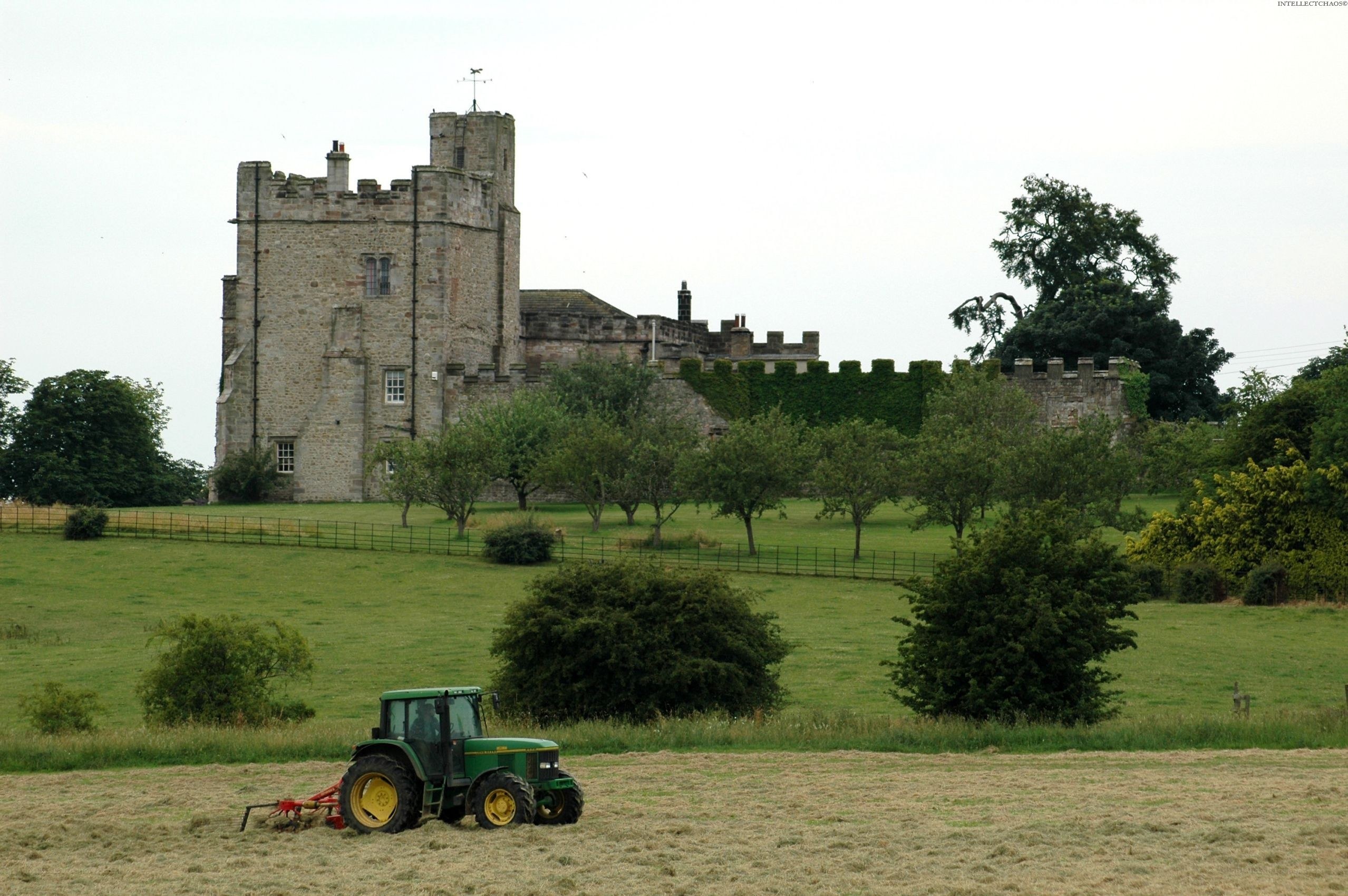 Tractor in field near castle