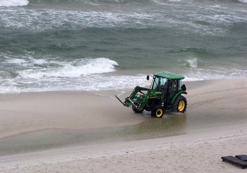 Tractor on a beach near waves