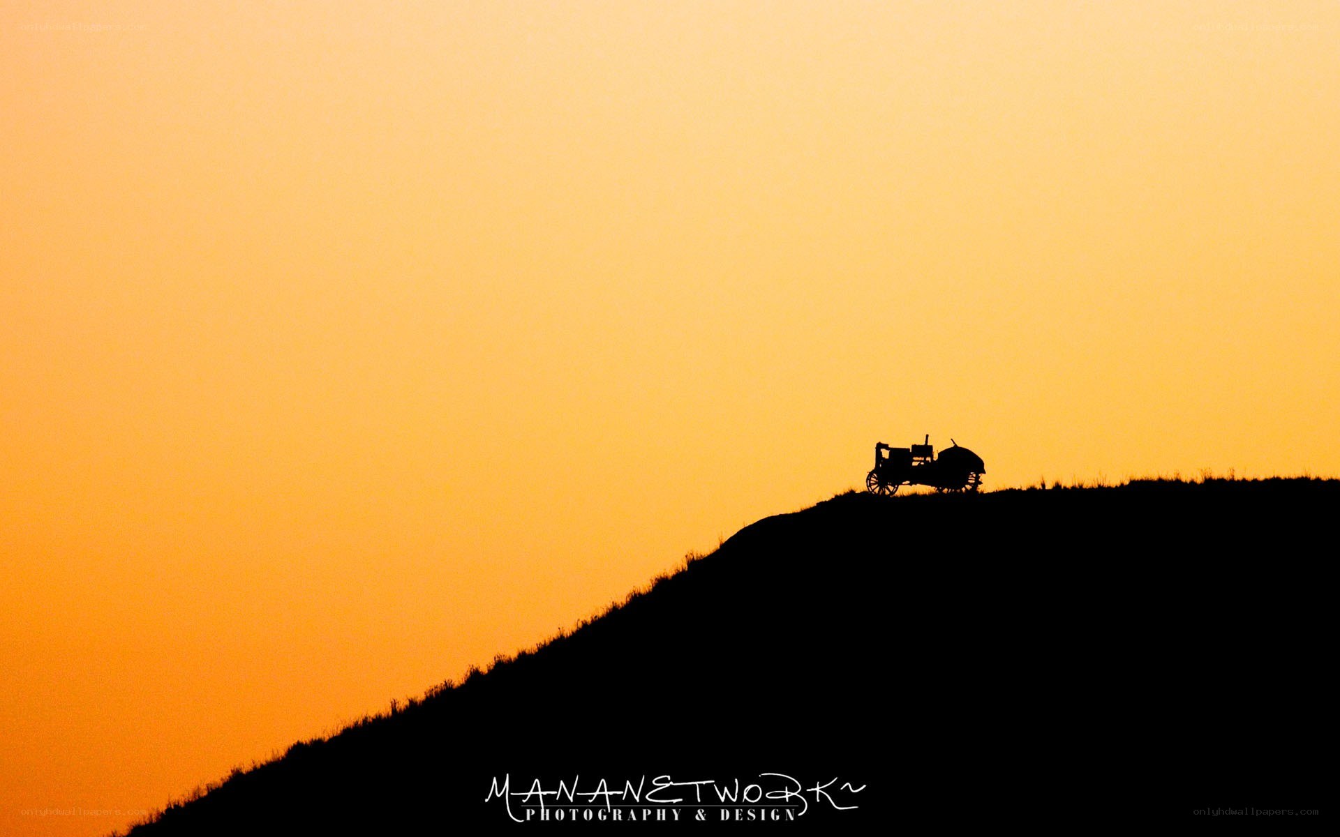 Tractor on a hill at sunset