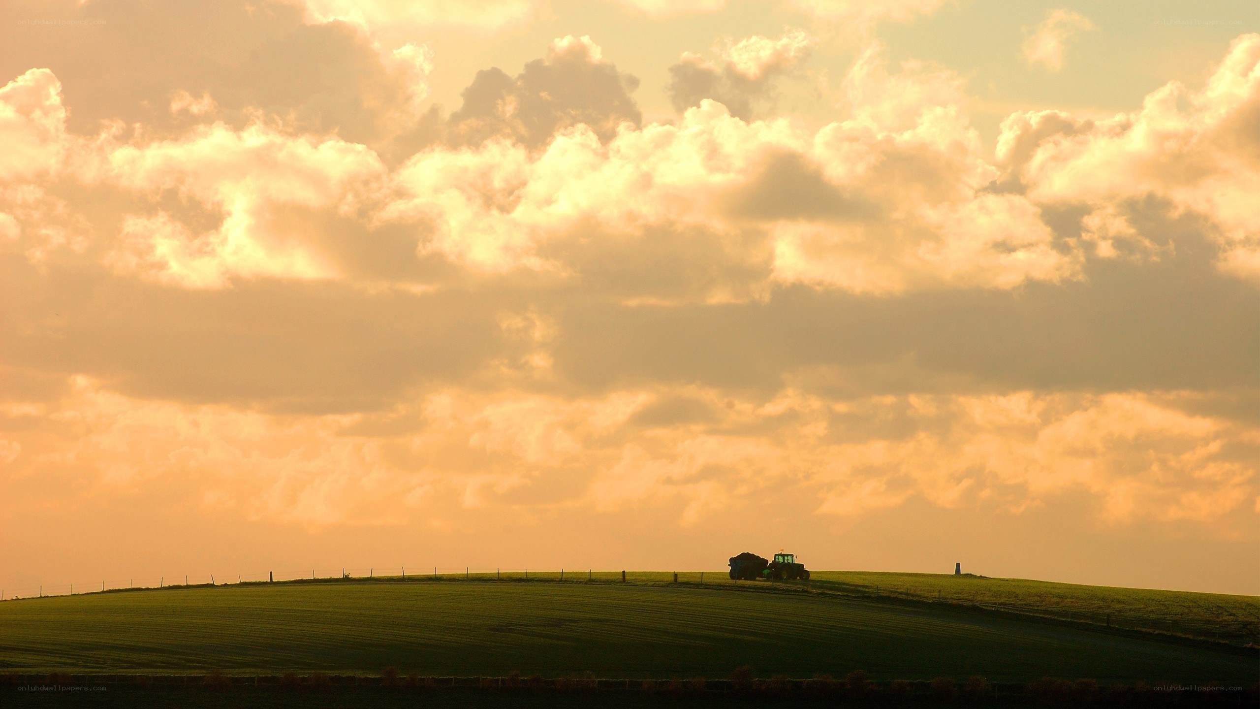 Tractor on a hill at sunset