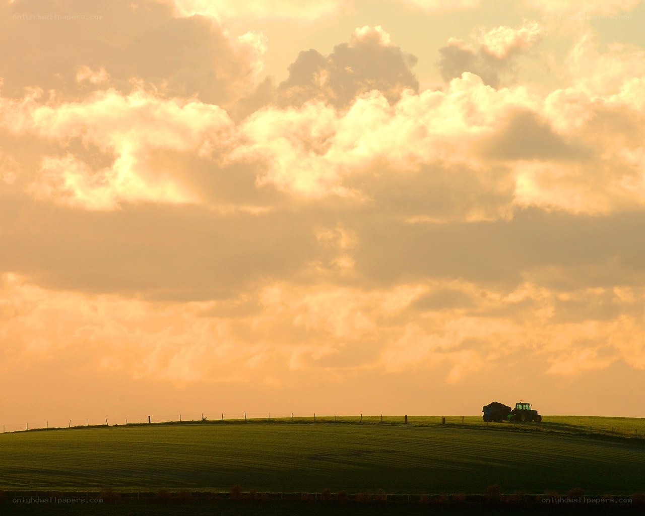 Tractor on a hill at sunset
