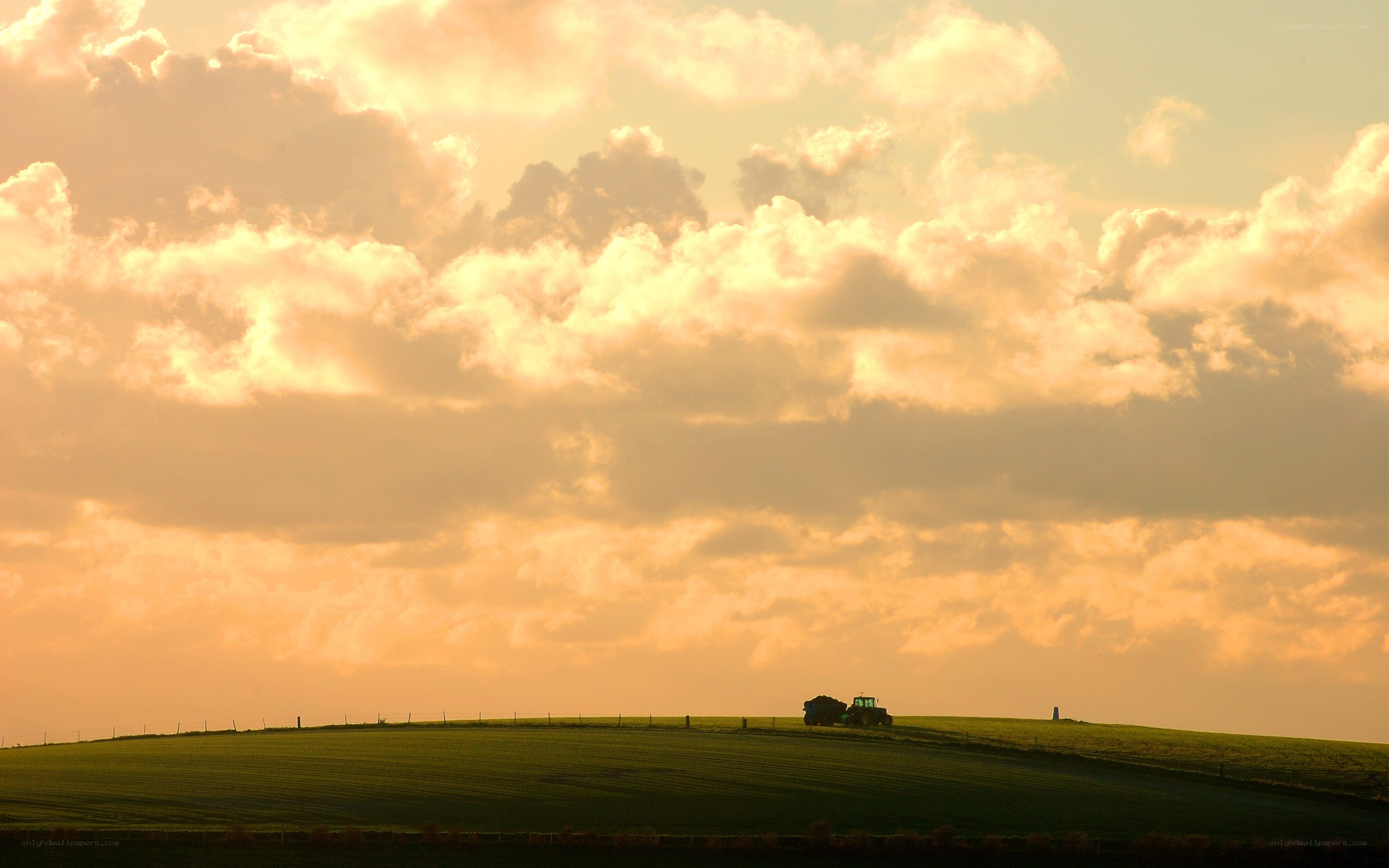 Tractor on a hill at sunset