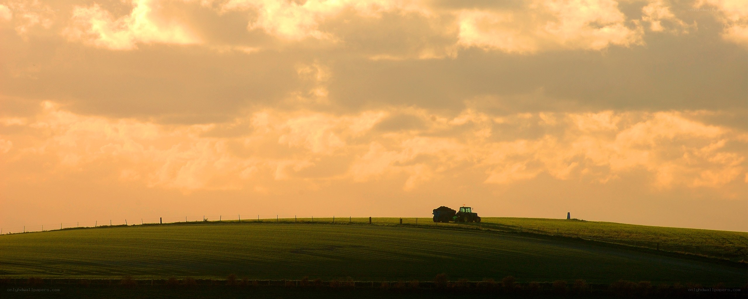 Tractor on a hill at sunset