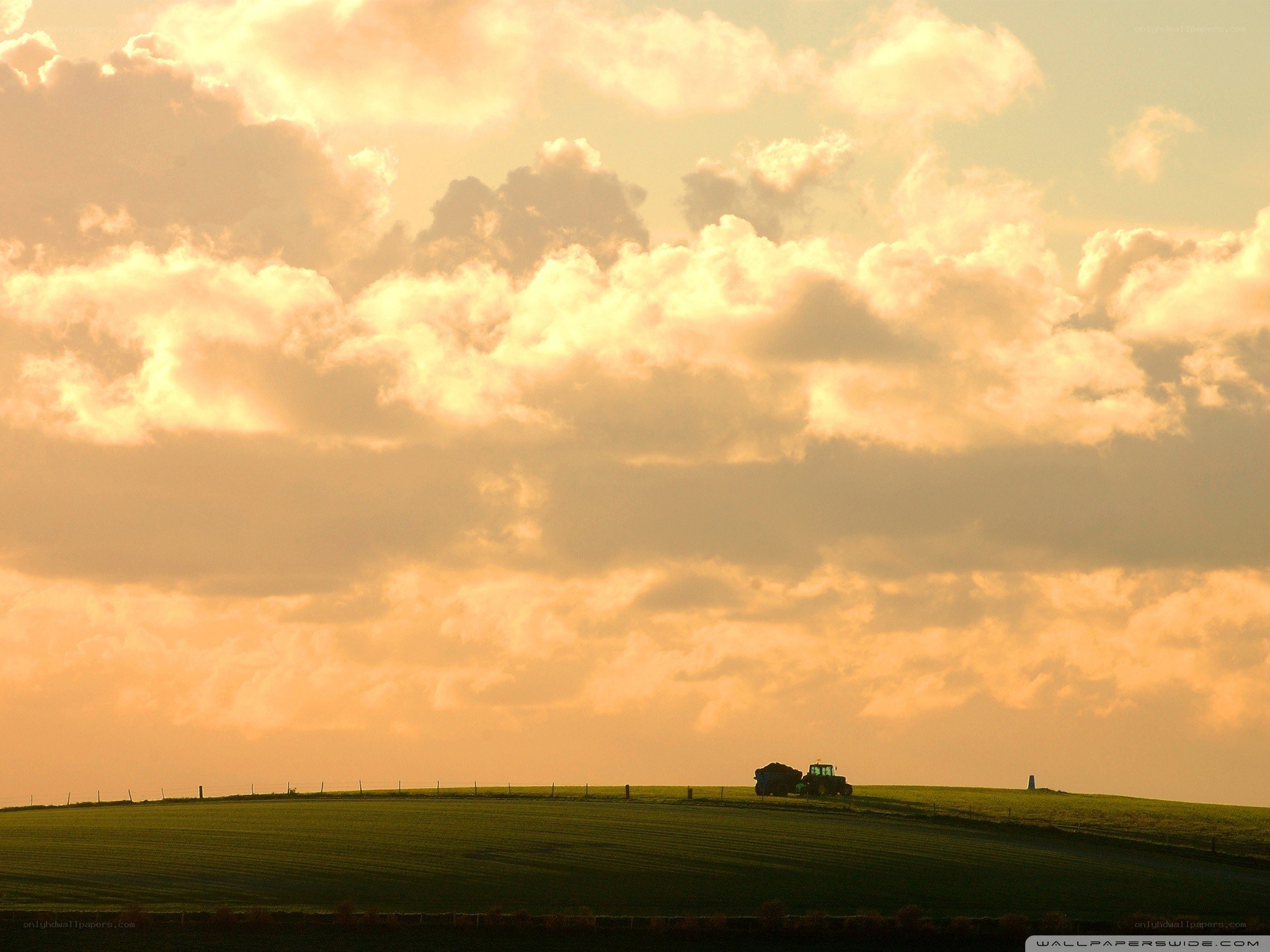 Tractor on a hill at sunset