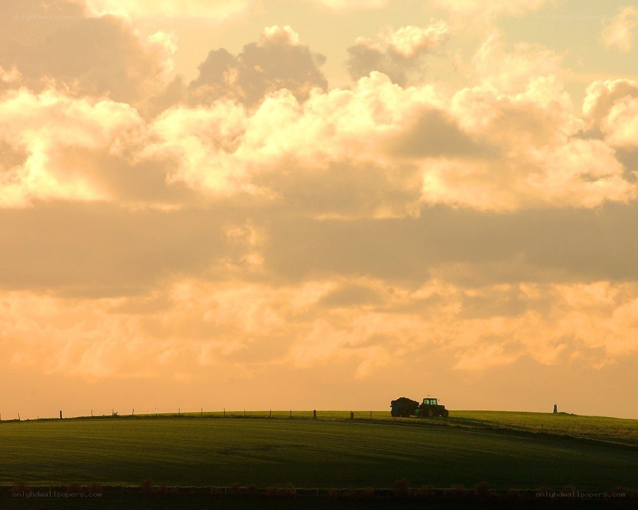 Tractor on a hill at sunset