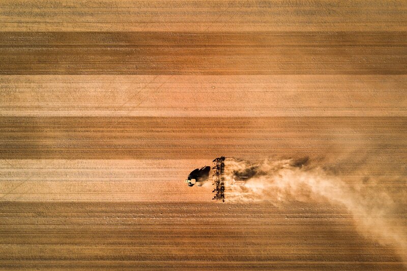 Tractor Plowing Field — Brown, Dusty