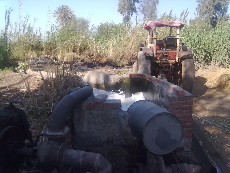 Tractor Pumping Water