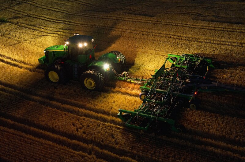 Tractor working in a field at night