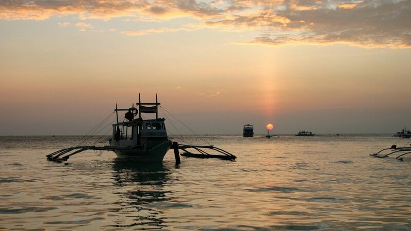 Traditional Boat at Sunset — Orange, Serene