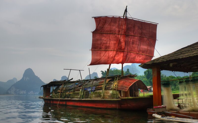 Traditional Boat with Red Sail