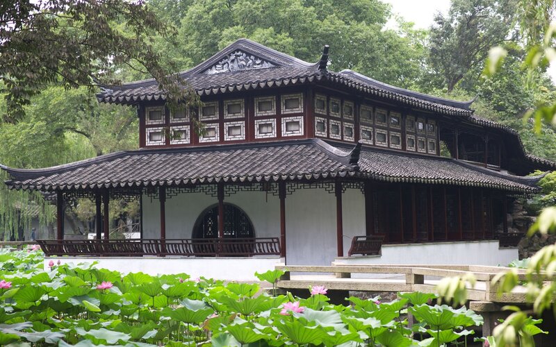 traditional chinese pavilion by lotus pond