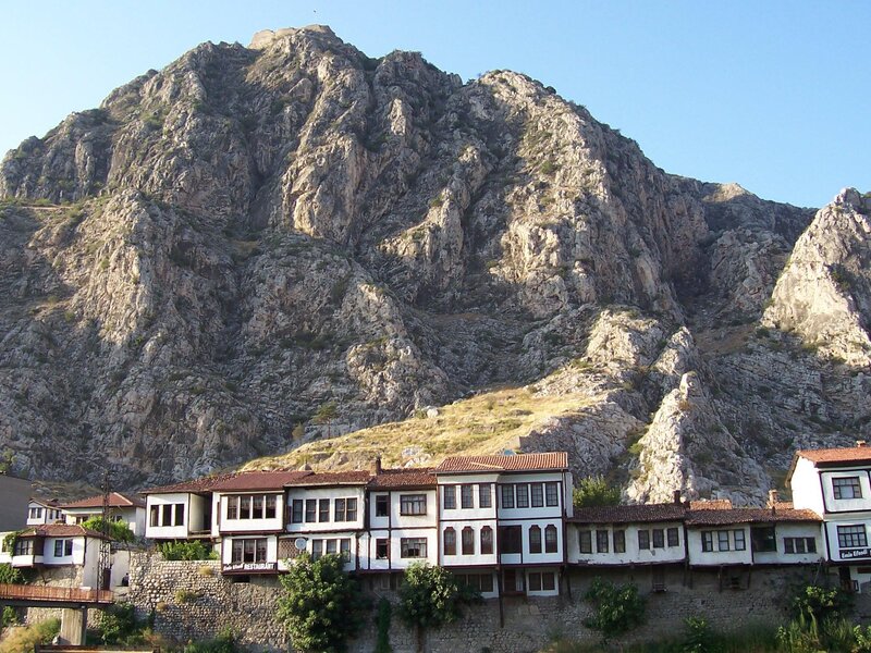 Traditional houses by a rocky mountain