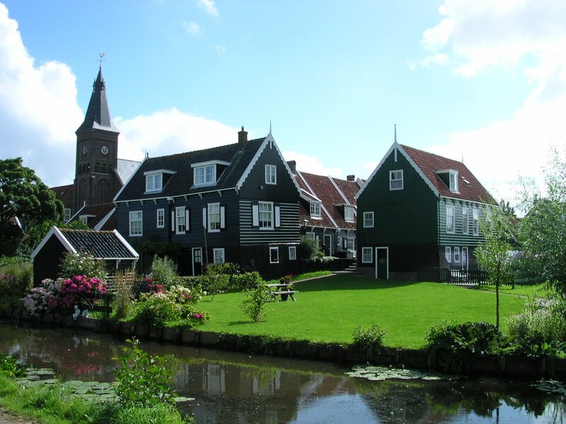 Traditional Houses by Canal — Green, Serene, Afternoon