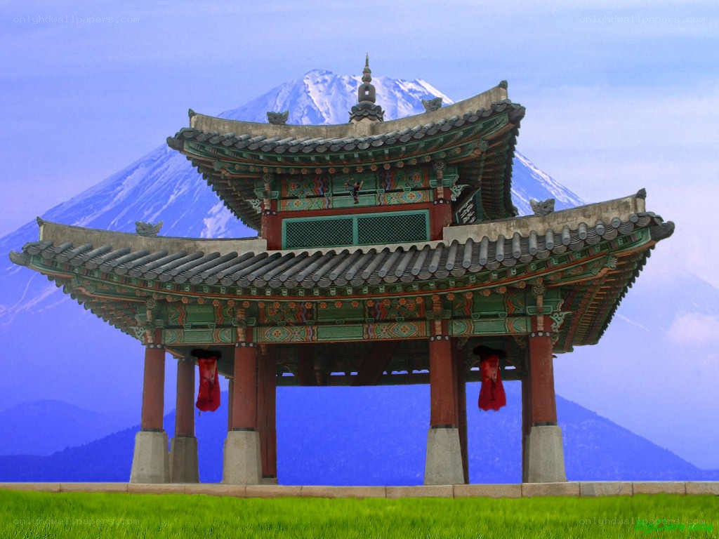 Traditional Korean pavilion with mountain