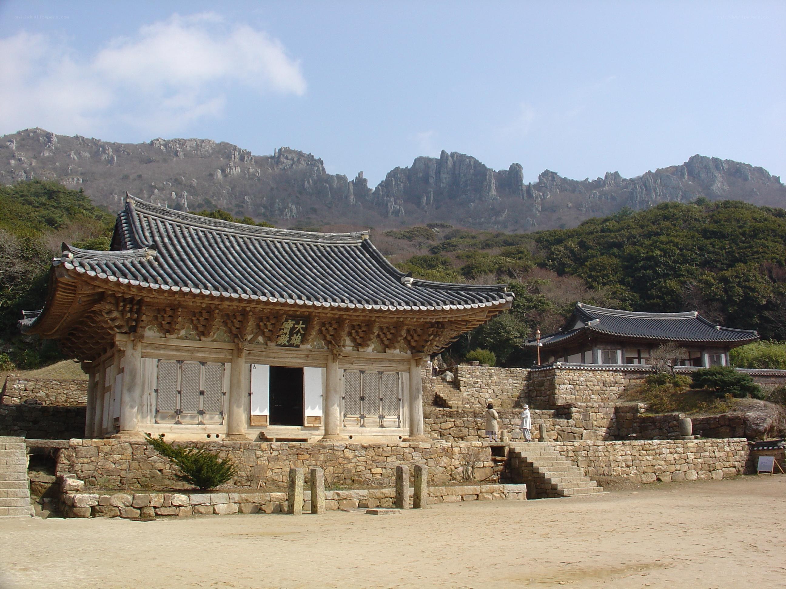 Traditional Korean temple with mountains