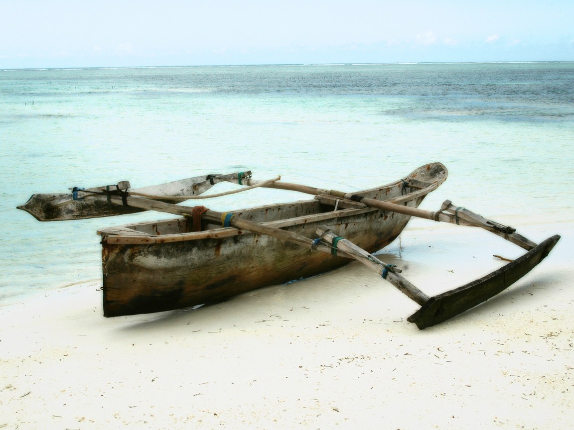 Traditional outrigger canoe on beach