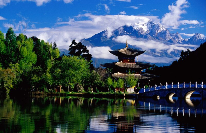 Traditional pagoda by a lake with mountain