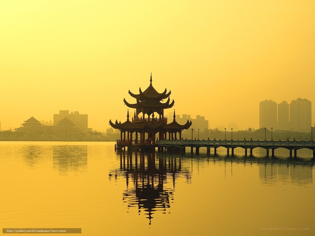 Traditional pavilion on a lake at sunset
