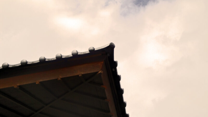 Traditional roof against cloudy sky