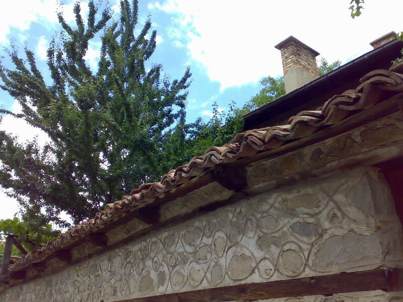 Traditional roof and stone wall
