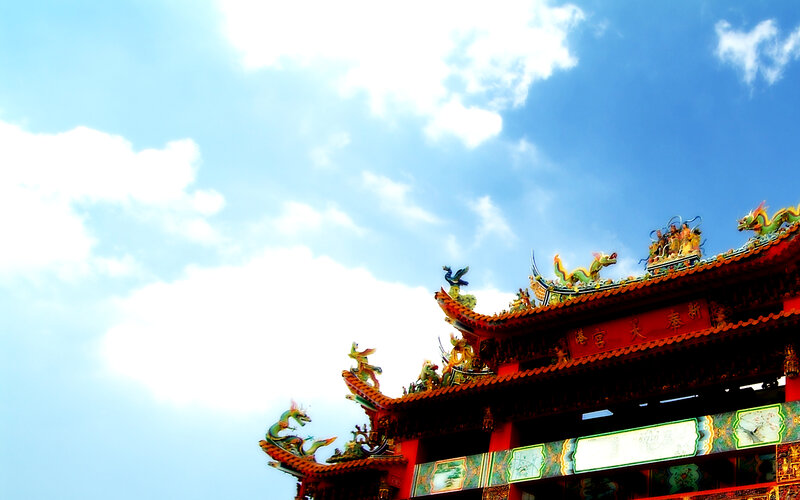 Traditional temple roof against blue sky
