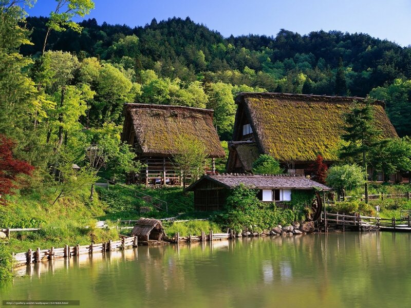 Traditional thatched-roof houses by a lake
