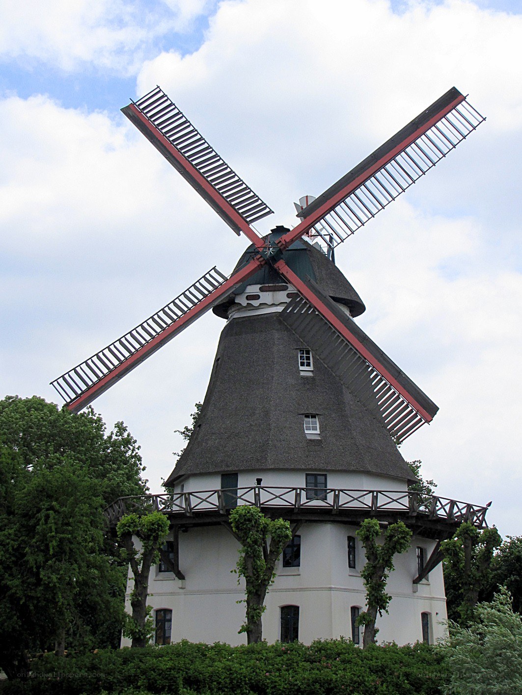 traditional windmill with red blades