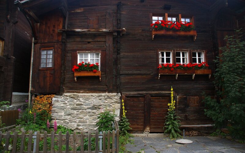 Traditional wooden house with flower boxes