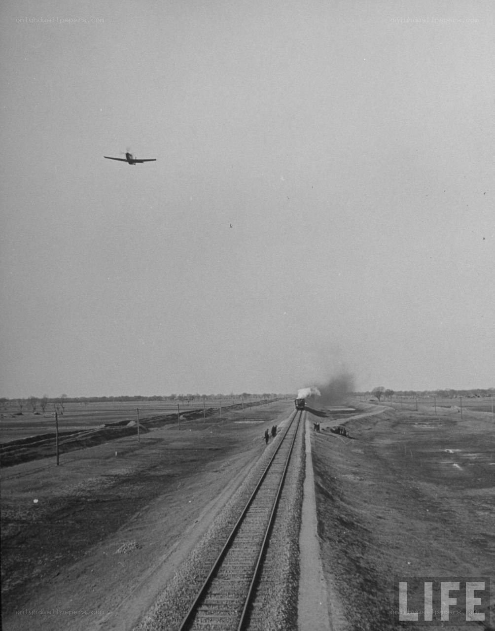 Train and plane in rural landscape