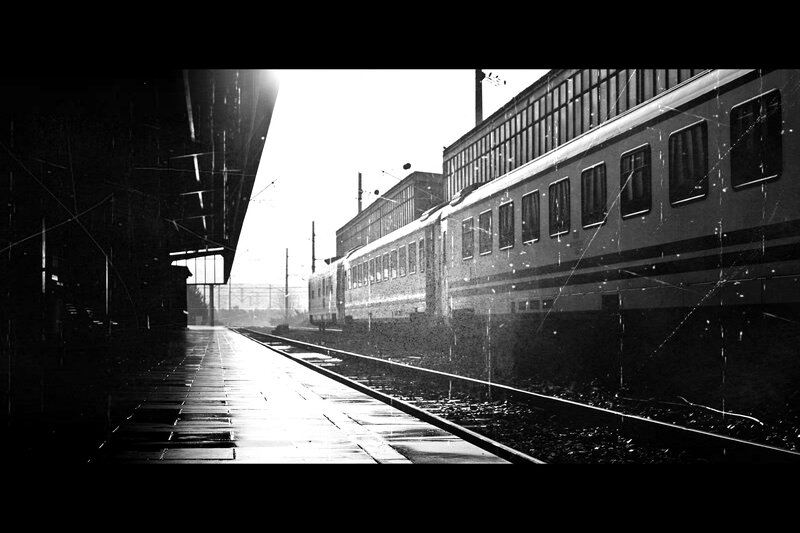 Train at a station in black and white