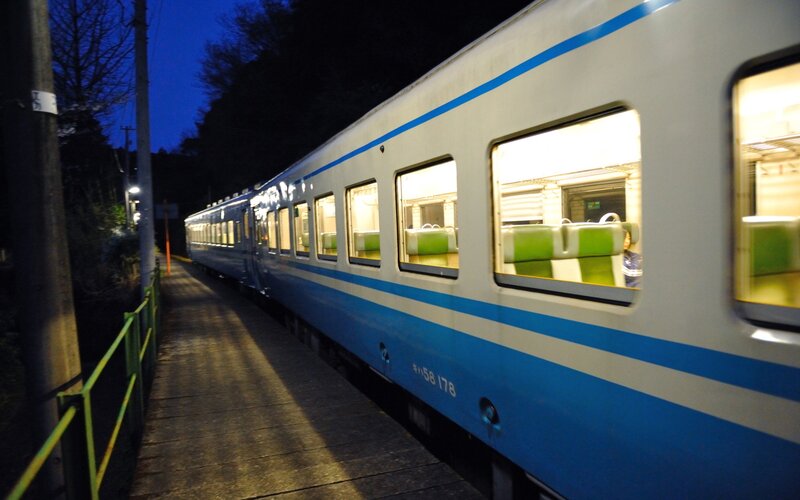 Train at night on a station platform