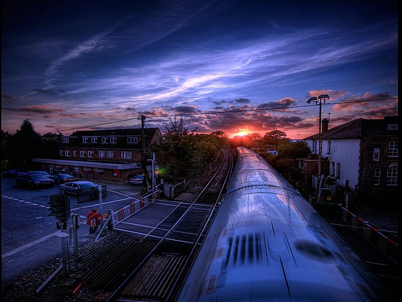 Train at sunset over crossing