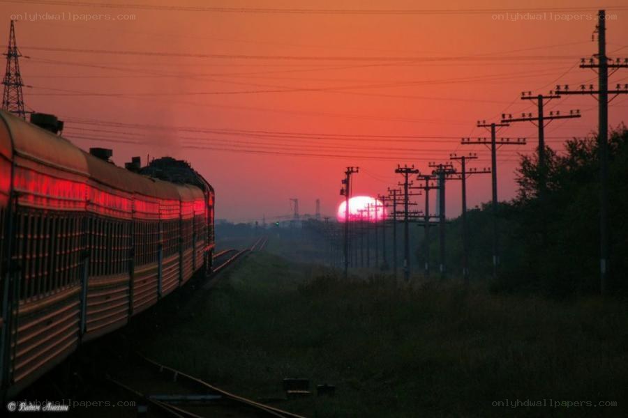Train at sunset with red sky